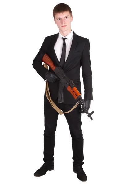 Man in black suit and ak 47 — Stock Photo, Image