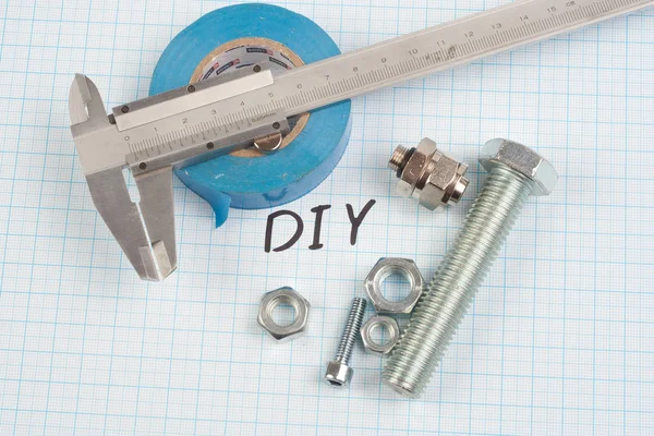 Screws, nuts, caliper and insulating tape — Stock Photo, Image