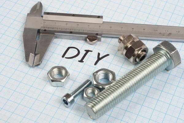 Screws, nuts and caliper — Stock Photo, Image