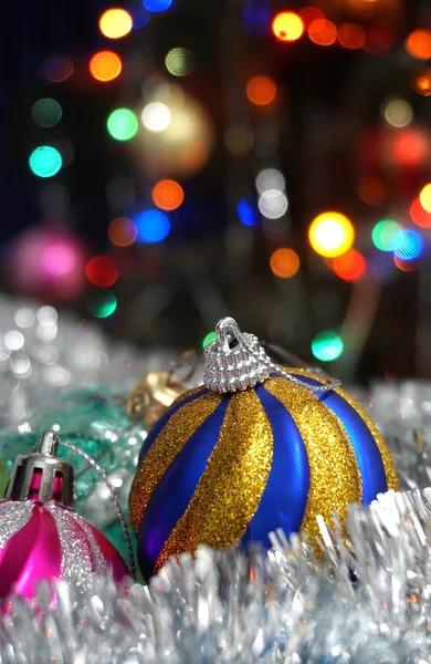 Christmas balls on the background of colored lights — Stock Photo, Image