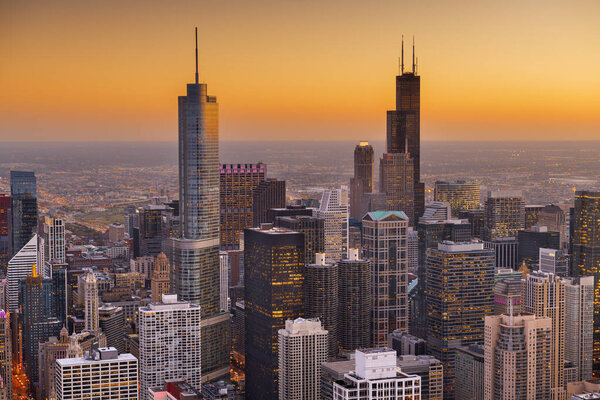Chicago, Illinois, USA aerial cityscape with financial district buildings at dusk.