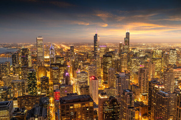 Chicago, Illinois, USA aerial cityscape towards Lake Michigan at dusk.