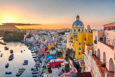 Procida, Italy old town skyline in the Mediterranean Sea during dusk.