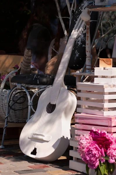 White guitar with peonies in bucket — Stock Photo, Image