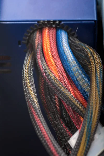 colored wires of the power supply near the computer close-up