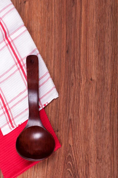Wooden spoon on towel — Stock Photo, Image