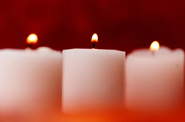 Three candles on red — Stock Photo, Image