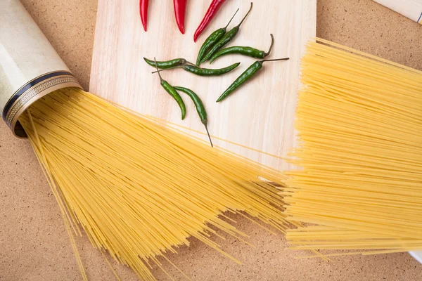 Pasta and chili peppers — Stock Photo, Image