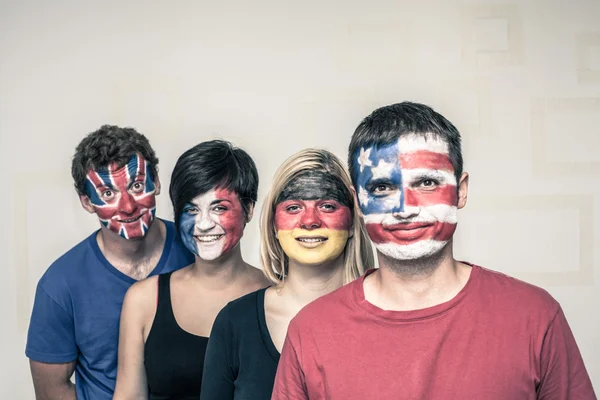 Happy people with flags on faces