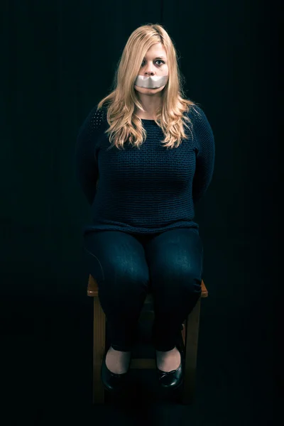 Kidnapped woman hostage with tape over her mouth — Stock Photo, Image