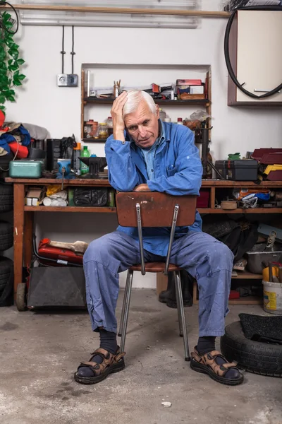 Frustrated senior worker in the workshop — Stock Photo, Image