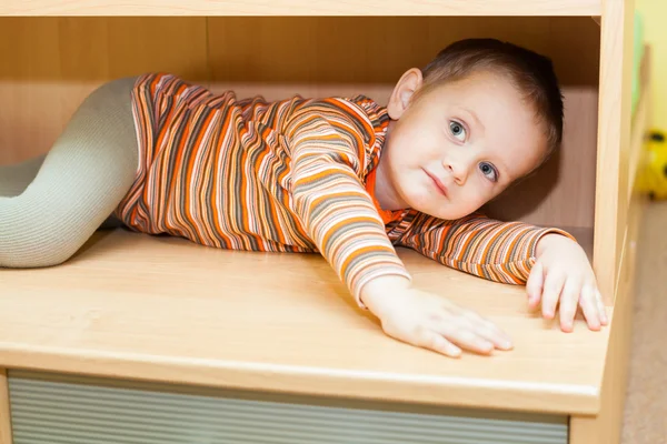 Child boy hiding in cupboard — Stock Photo, Image