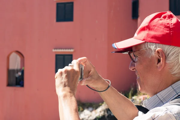 Homme âgé prenant des photos avec appareil photo compact — Photo