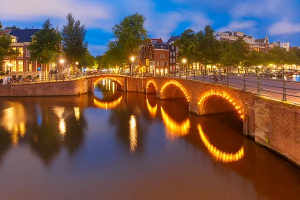 Night city view of Amsterdam canal and bridge — Stock Photo, Image