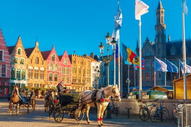 Horse carriage at Christmas morning on Markt square of Brugge clipart