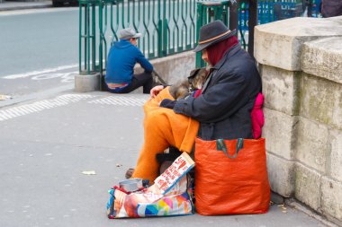 Clochard, homeless with dog in Paris clipart
