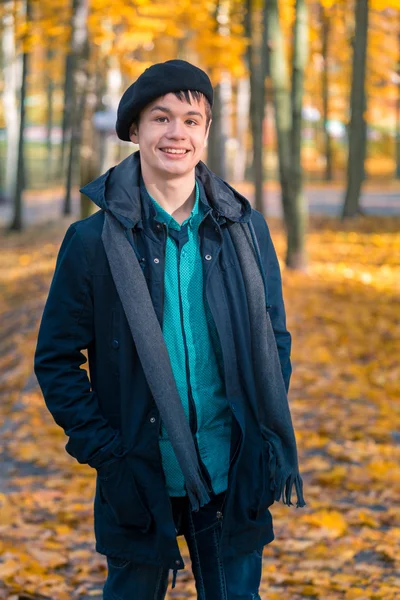 Happy teenage boy in the autumn sunny park — Stock Photo, Image