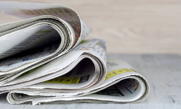 A close up of a small pile of newspapers with copy space for your text