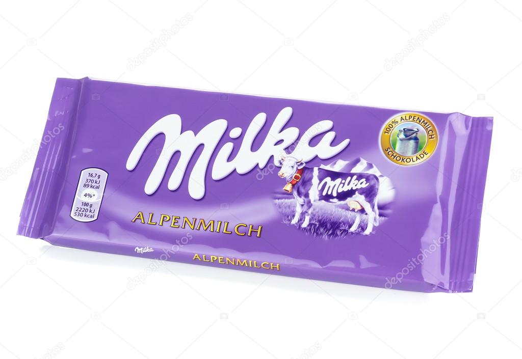 NIEDERSACHSEN, GERMANY SEPTEMBER 12, 2014: A bar of Milka Mondelez Alpenmilch milk chocolate with the purple Milka cow on a white background