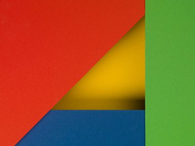 Sarı, kırmızı, yeşil ve mavi kağıttan yapılmış soyut arkaplan, üst görünüm.