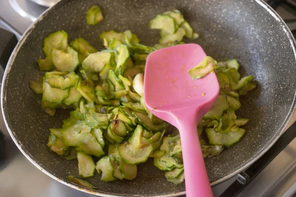 slices of stewed zucchini in a pan