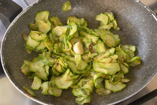 slices of stewed zucchini in a pan