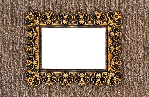 Golden painted frame with repeating abstract elements on decorative plaster background.