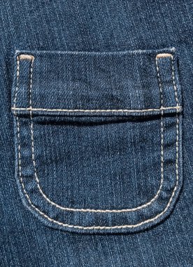 Small pocket on blue denim with white stitches.