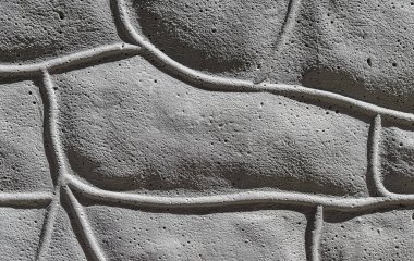 Tuğla taklidiyle gözenekli gri çimento dokusu.