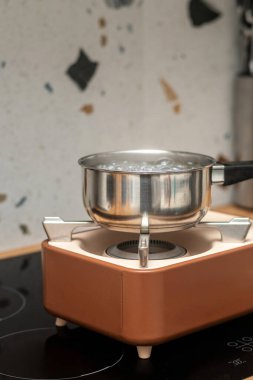 Elektrik kesintisi sırasında mutfak masasında kamp yapmak için taşınabilir gaz tüpü.