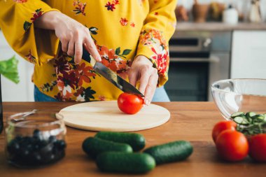 Genç ve güzel hamile kız mutfakta sebze salatası hazırlıyor. Sağlıklı beslenme kavramı. Tonlama.