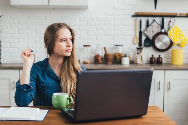 Genç ve güzel hamile bir kız. Karantinada kendini soyutlama modunda mutfakta çalışan bir serbest çalışan. Tonlama.