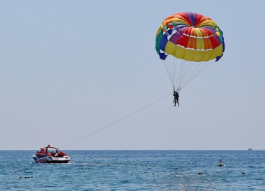 Parasailing in a blue sky clipart
