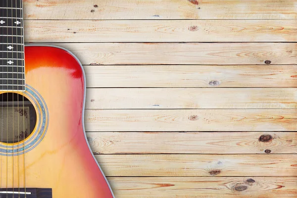 Guitarra sobre un fondo rústico de madera — Foto de Stock