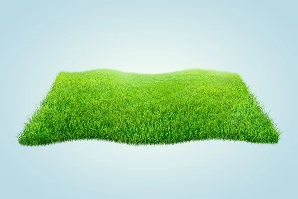 Kwadratowe pola zielona trawa na niebieskim tle — Zdjęcie stockowe