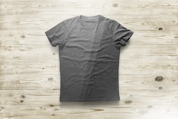 Grey shirt over wood background — Stock Photo, Image