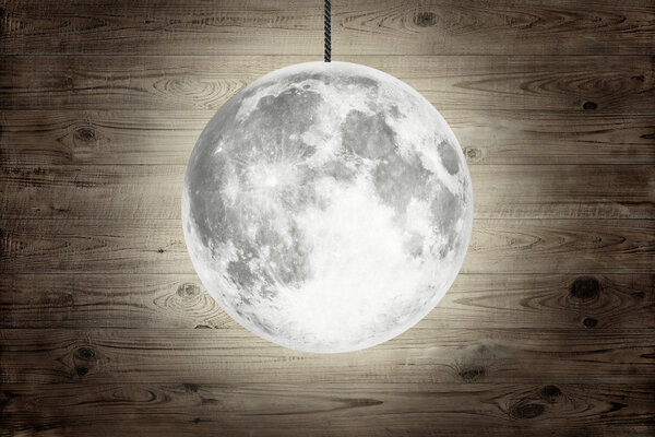 Full moon over wood background