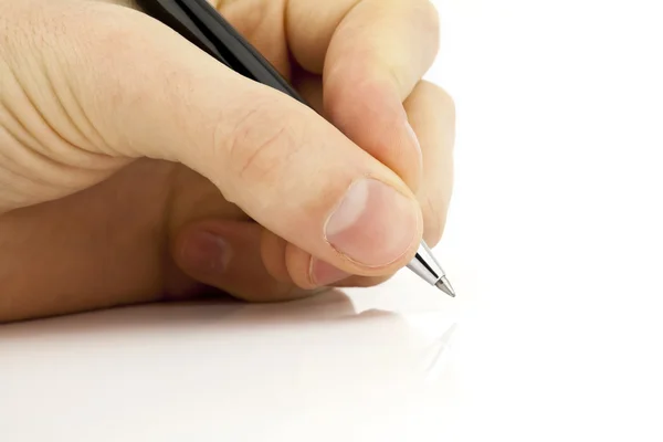 Hand holds a pen writing — Stock Photo, Image