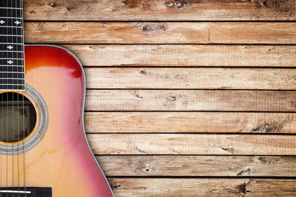 Guitarra contra fondo de madera — Foto de Stock