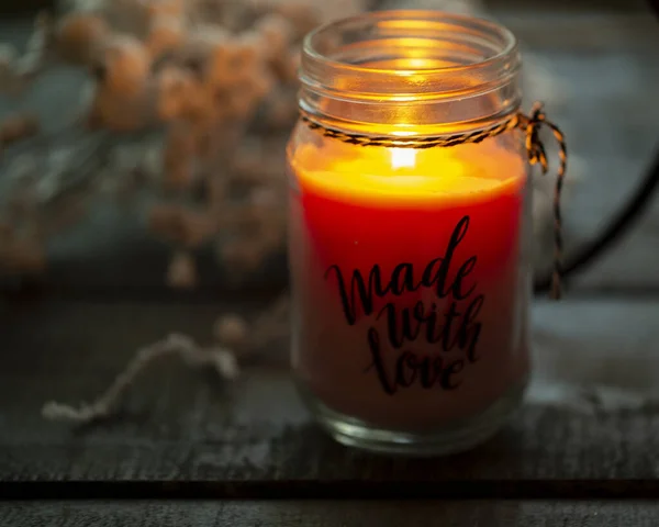 burning candle on a dark wooden background close-up