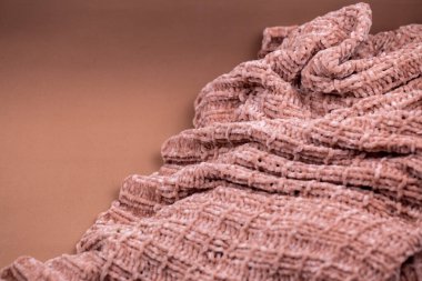 Pembe örgü battaniyenin dokusu yakın plan çekimle örtülmüş.