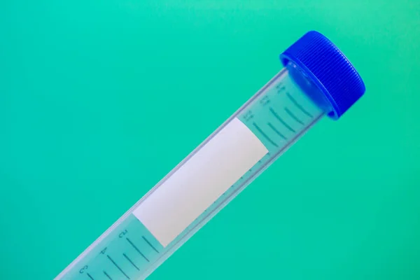 medical test tube with recording tag and blue plastic cover close-up