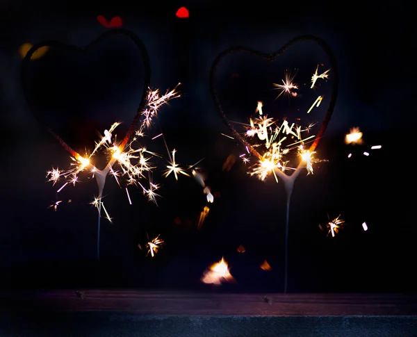 Sparkler Form Burning Heart Surrounded Colorful Bokeh Close — Stock Photo, Image