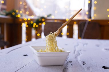 frozen noodles on a fork on a very cold day in Siberia, cold temperature clipart