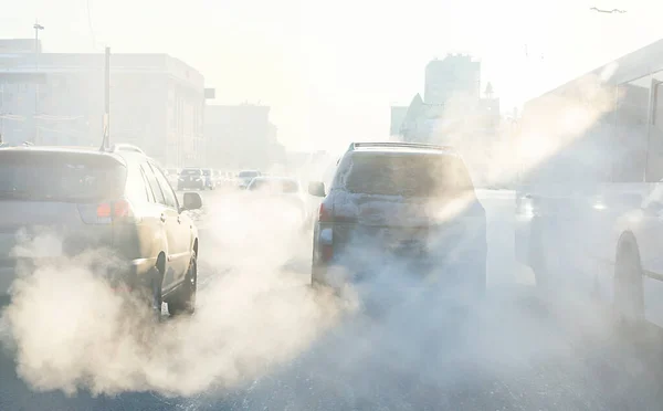 air pollution from exhaust fumes from cars in the city, on a cold day, air pollution in cities