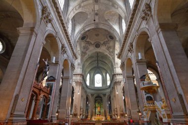 PARIS, FRANCE - JULY 23, 2011: People visit Saint Sulpice church in Paris. It is located in Latin Quartier, 6th arrondissement of Paris.