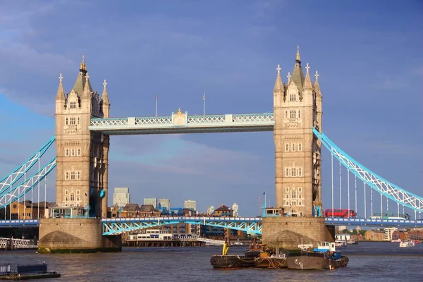 Tower Bridge - landmark in London UK. Old London landmarks. Red doubledecker bus on bridge.