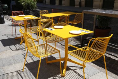 Polonya 'da bir kafe. Varşova, Polonya - Sarı çelik sandalyeli modern hipster kafe ve açık masa.