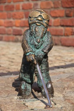 WROCLAW, POLAND - 2 Eylül 2018: Wroclaw, Polonya 'da körlük küçük heykeli olan engelli cüce veya cüce. Wroclaw 'ın şehirde çeşitli sanatçıların 350 cüce heykeli var..