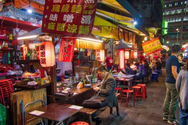 TAIPEI, TAIWAN - 4 Aralık 2018: İnsanlar Taipei 'deki Raohe Gece Pazarı' nı ziyaret ediyor. Gece gıda pazarları Tayvan kültürünün büyük bir parçasıdır..